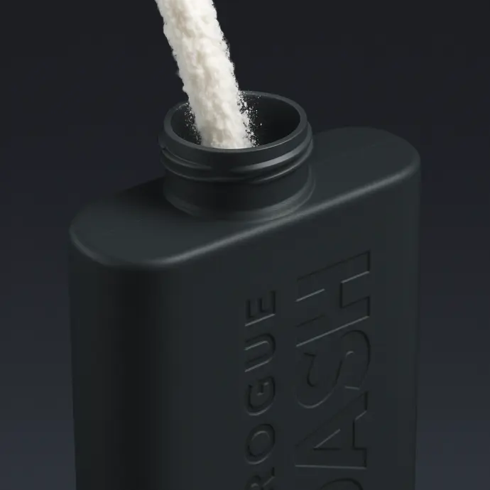 Rogue Dash refillable bottle being filled with shower gel powder